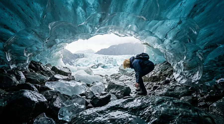 Standing Inside a Natural Ice Cave Carved Beneath a Floating Glacier