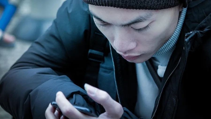 He Reaches for His Phone in Every Quiet Moment